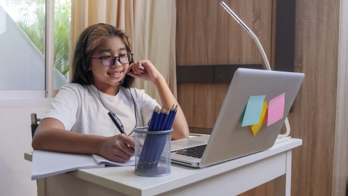 Girl sitting at desk with laptop