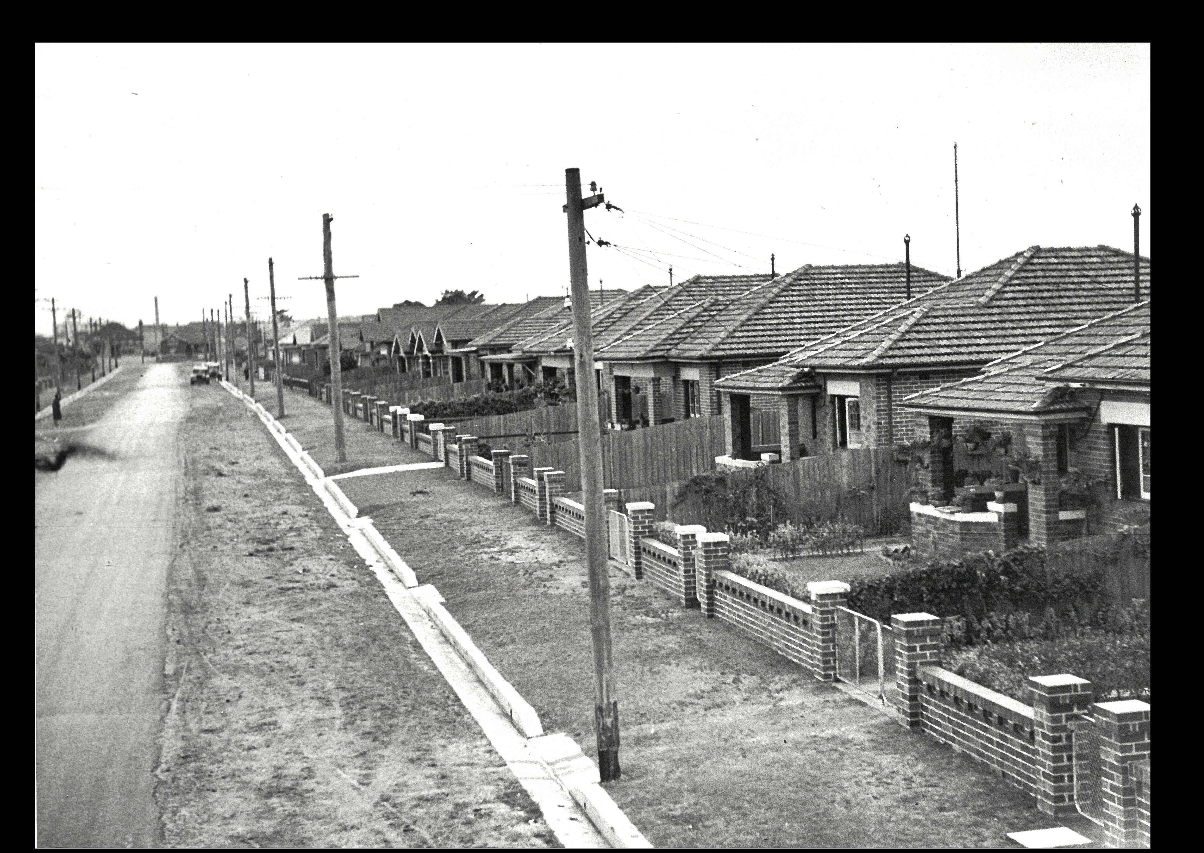 historical photo of houses along a street