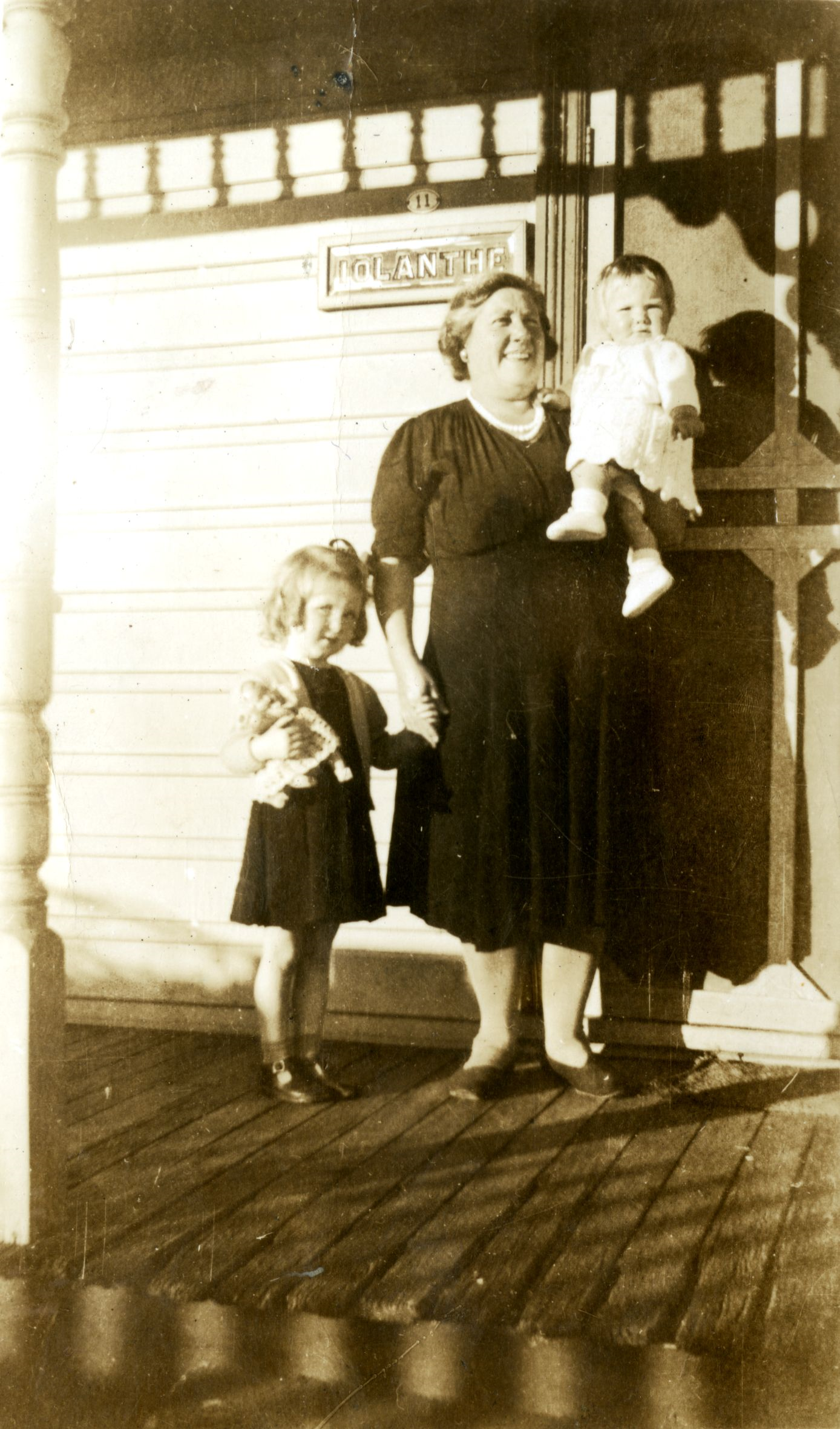 historical photo showing residents at front door of home